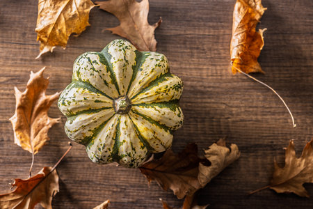 Sweet dumpling pumpkin on a wooden table. Top view.の写真素材