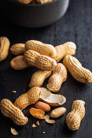 Peanuts on a black table.