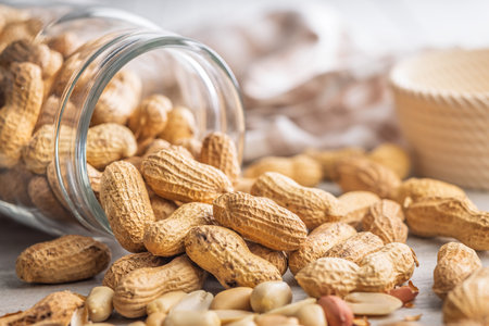 Peanuts in shell. Groundnuts in a jar on a kitchen table.の写真素材