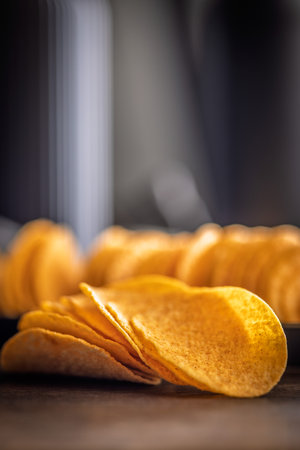 Crispy potato chips on a wooden table.の写真素材