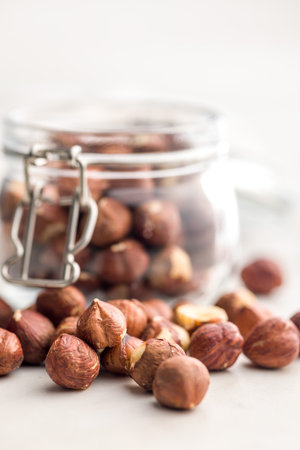 Peeled hazelnut kernels on a kitchen table.の写真素材