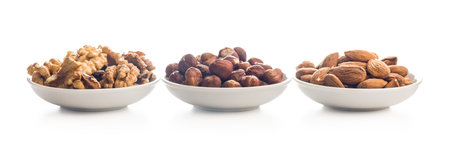 Peeled walnut, hazelnut and almond kernels isolated on a white background.