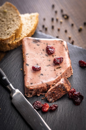 Liver pate with cranberries on a stone cutting board.の写真素材