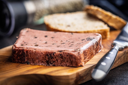 Liver pate with cranberries on a wooden cutting board.の写真素材