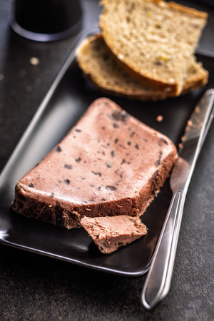 Liver pate with cranberries on a black plate.の写真素材