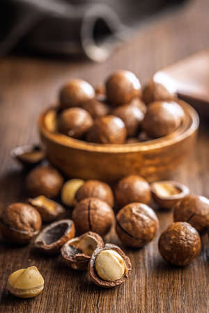 Tasty macadamia nuts on a wooden table.の写真素材