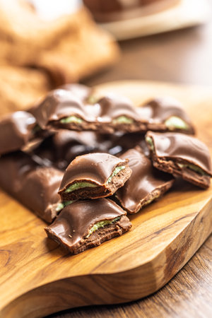 Chocolate bar with pistachios cream on a wooden table.
