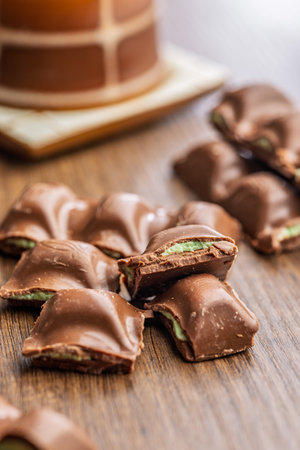 Chocolate bar with pistachios cream on a wooden table.の写真素材