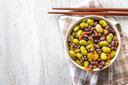 Fresh salad with edamame beans in a bowl on a checkered napkin. Top view.の写真素材