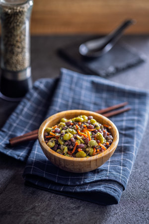 Fresh salad with edamame beans in a bowl on a black table.の写真素材