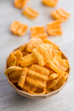 Crispy salted chips on a kitchen table.