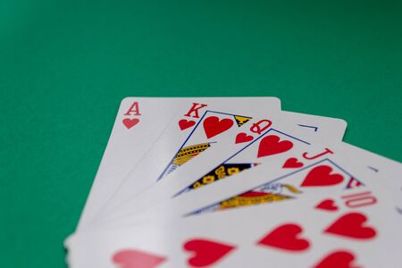 Poker table with a variety of fanned out cards on the table