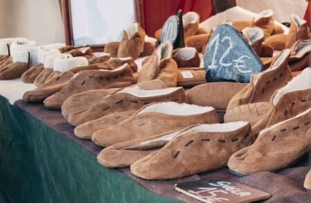 Stall selling medieval shoes. Craft marketの写真素材