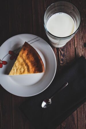 Top view glass of milk with cheese cake. Dessert