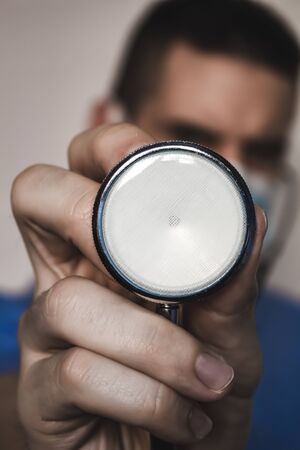 Doctor with a stethoscope in his hands. covid-19 telemedicine conceptの写真素材