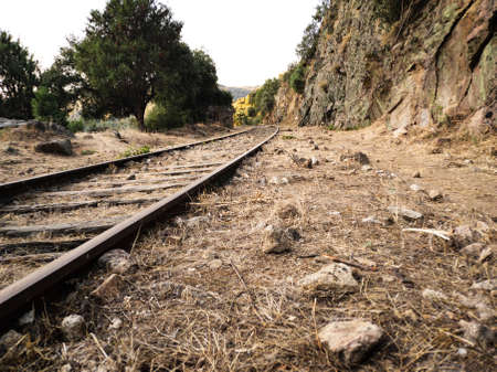 Abandoned railroad tracks through the mountainsの写真素材
