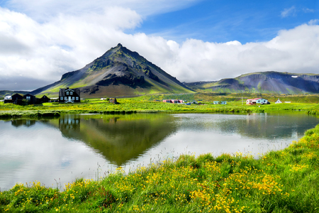 Beautiful fishing village view of Arnarstapi with water reflection of Mount Staoafell in the background at Snaefellsnes Peninsula, Icelandの写真素材
