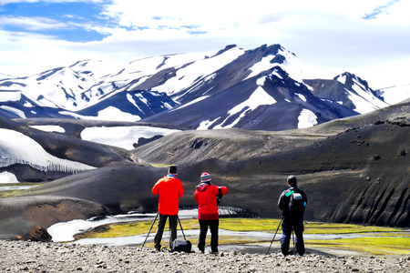 Photographers standing in front of beautiful volcanic mountains in the national park Landmannalaugar, Icelandのeditorial素材