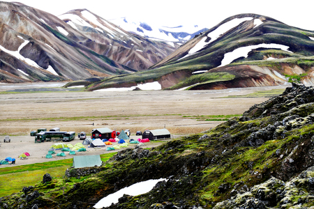 Camping huts with beautiful landscape view of multicolored volcanic mountains in the background in summer time at National Park Landmannalaugar, Icelandのeditorial素材