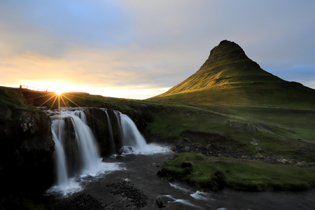 Famous Kirkjufell mountain and Kirkjufellsfoss at sunset on Snaefellsnes peninsula, Iceland summerの写真素材