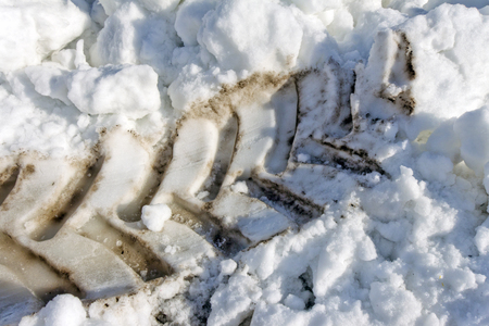Dirty trace from a big tractor on pure snow in the winterの写真素材