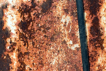 Black rubber hose in the background of old and rusty ironの写真素材