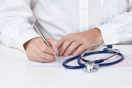 Family doctor write prescription (recipe)の写真素材