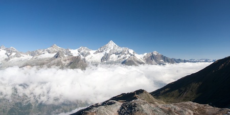 Weisshorn mountain and Mattertal valley with morning clouds, Alps, Switzerlandの写真素材