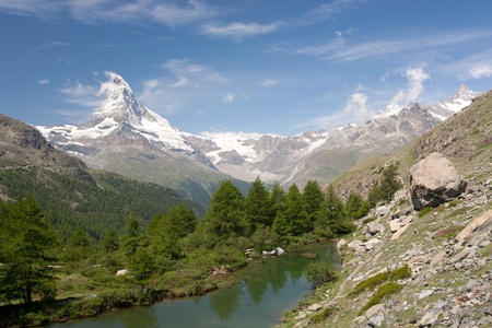 Matterhorn mountain with morning clouds reflecting in Moosjisee, Alps, Switzerlandの写真素材