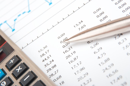 Business analyst workplace - calculator, spreadsheet and penの写真素材