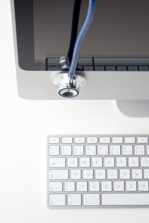 Doctor out of office - stethoscope situated on computer LCD