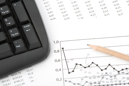 Concept of market share analysis - pencil; graph; sheet with numbers and keyboardの写真素材