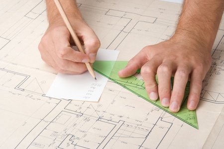 Architect calculate dimensions on his project of interior