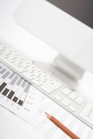 Concept of market share analysis - pencil; graph; sheet with numbers, keyboard and computerの写真素材