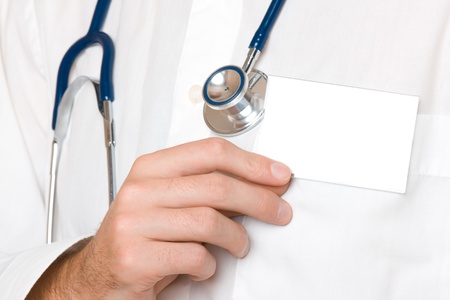 Doctor with stethoscope hold his blank visiting card - place your textの写真素材