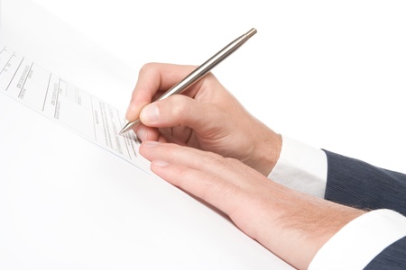 Signing a contract - hand with pen closeupの写真素材