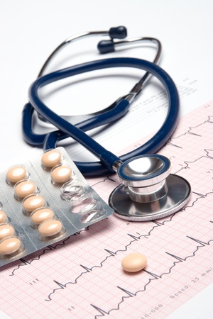 Part of stethoscope, electrocardiogram (ECG) and pills - heart healthcare conceptの写真素材