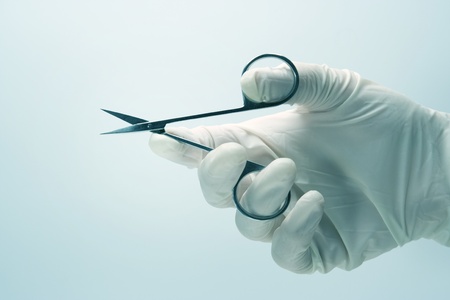 Surgeon with surgical gloves and shearの写真素材