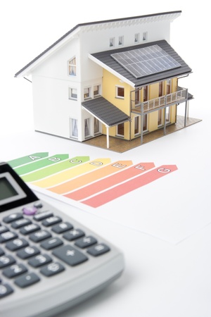 Calculator, energy efficiency rating graph and model of the active house.  Focused oh graph and part of the house.の写真素材