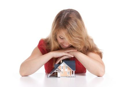 Young woman with model of house.
の写真素材