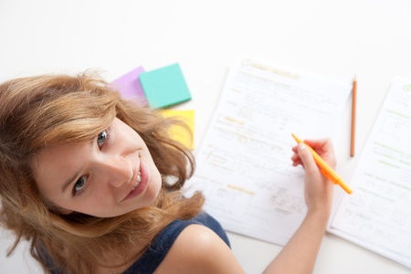 College student studying (swot up) for exam. Focused on face. Top view.の写真素材