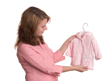 Pregnancy concept without showing abdomen - pregnant woman pick clothing for her unborn daughterの写真素材