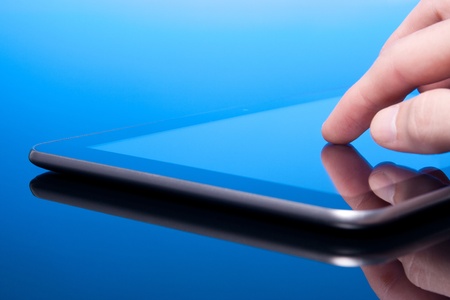 Man working with tablet computer  blue tint   Touching screen on tablet PC の写真素材