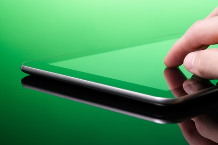 Digital publishing is green  ecological  concept  Man working with tablet computer  green tint   Touching screen on tablet PC の写真素材