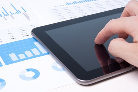 Modern business analyst working with digital tablet computer, sheet and graphs の写真素材