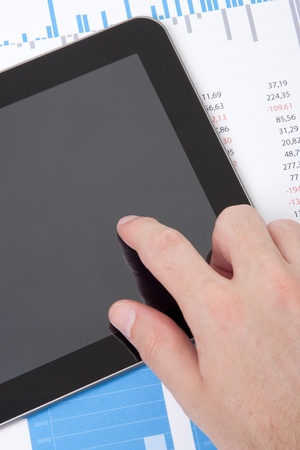 Modern business analyst working with digital tablet computer, sheet and graphs  Vertical composition, top view の写真素材
