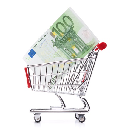 Spending money concept - shopping cart  shopping trolley  with money の写真素材