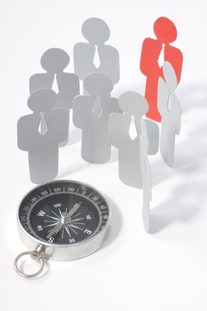Looking for exceptional employee (represented by paper figures). Headhunters equipment - compass.
の写真素材