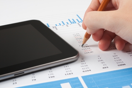 Concept of business report analysis - hand with pencil, digital tablet, graph and sheet  You may place your own screen, for example web page on tablet screen の写真素材