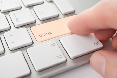 Censor press keypad on his keyboard. Internet censorship (expurgate, monitoring and control) threat concept.の写真素材